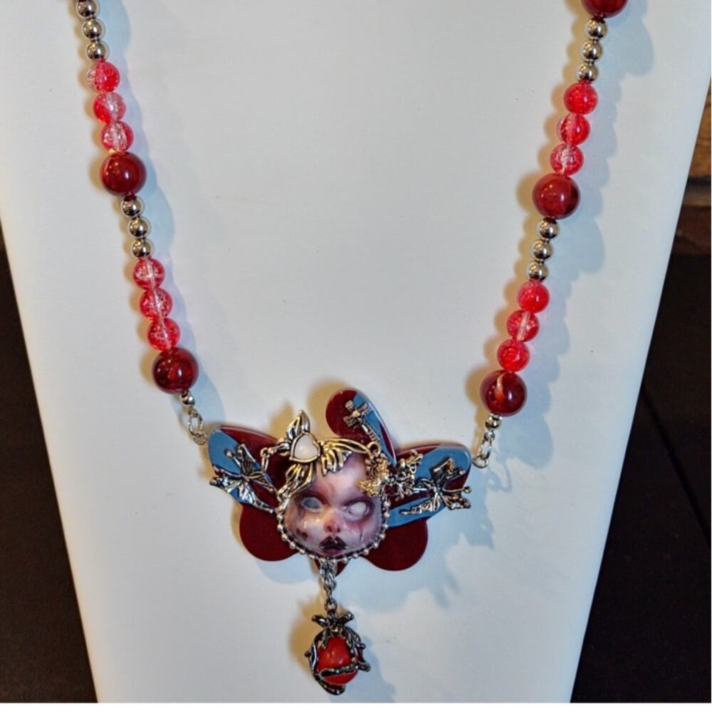 Gothic Doll Necklace With Creepy Face Pendant Accented with Red & Silver beads